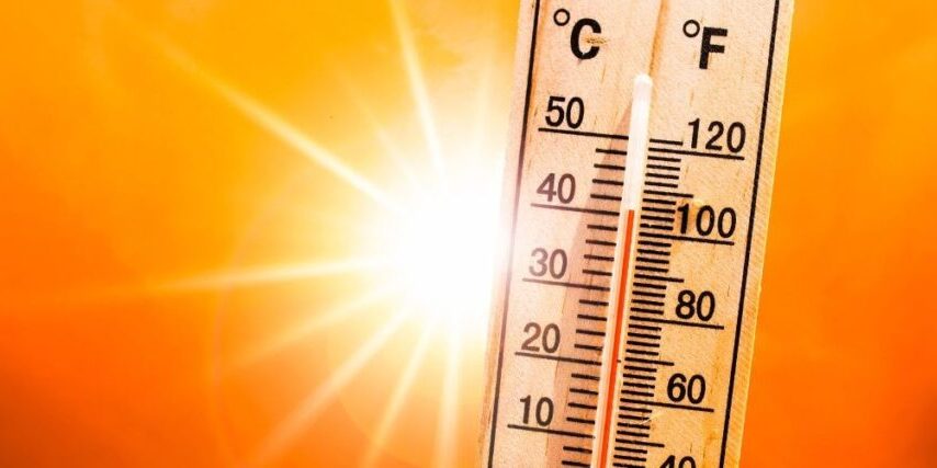 Titan-blog-featured-2025-Jul-sun-wooden-thermometer Wooden thermometer reading over 40°C (100°F) against an orange background with sun flare, signifying the importance of protecting trees from extreme heat.